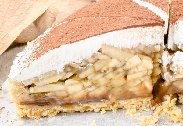 Banoffee pie on wooden table in soft light — Stock Photo, Image