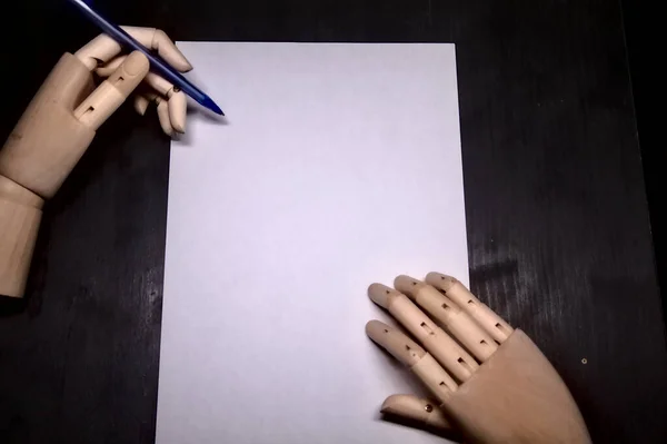 Two Wooden Hands Act Writing White Sheet — Stock Photo, Image