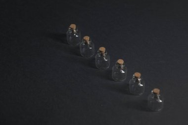 Siyah arkaplanda tıpaları olan küçük ampuller