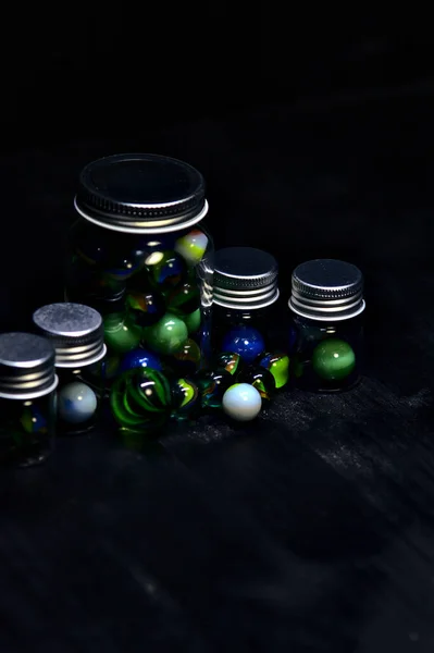 Jar Colored Marbles Black Surface — Stock Photo, Image