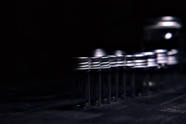 Siyah bir yüzeye boş küçük kavanozlar.