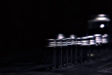 Siyah bir yüzeye boş küçük kavanozlar.