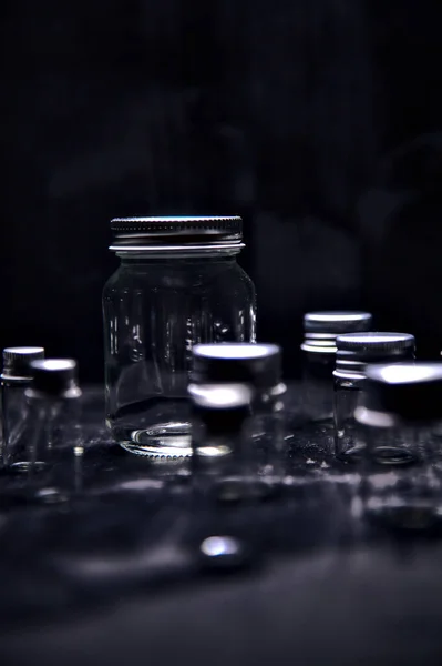 Empty Tiny Jars Black Surface Stock Picture