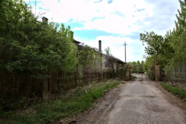 Bulutlu bir günde terk edilmiş bir kır evine giden yol