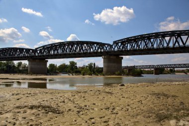 Railway bridge on a dried river in the italian countryside in spring