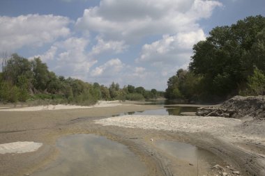 Almost dried inlet of a river in spring in the italian countryside