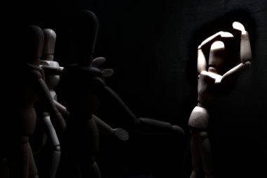 Duvara dayanmış umutsuzluğa kapılmış mankenler çiziyor.