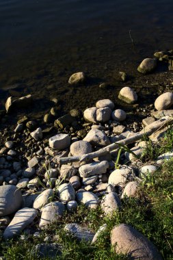 Rocky shore of a lake at sunset