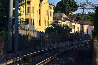 Railway track in an italian town at sunset in summer