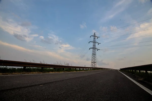 stock image Bike path in the countryside with a cloudy sky at sunset in summer