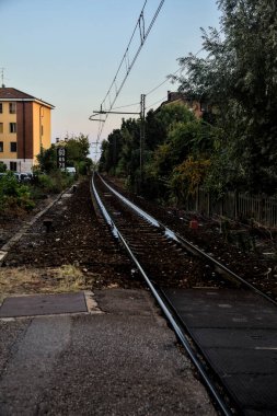 Tren yolu gün batımında bir yerleşim alanından geçiyor.