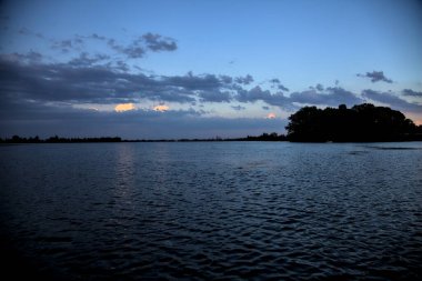Bulutlu bir günde, alacakaranlıkta nehirde bir kanal.