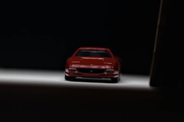 Mantova, İtalya - 12. SEPTEMBER 2025 - Bir Ferrari F355 'in Takara Tomi kopyası kemerli bir karton tünelin altından geçiyor