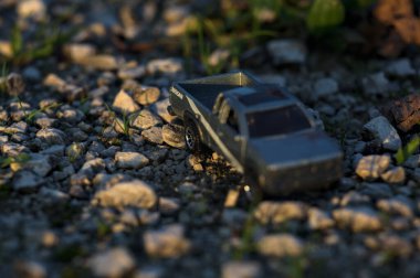 Stradella, İtalya - 10 Ekim 2025 - 2017 Nissan Hardbody 'in çakıl taşı ve çimenlerin gün batımında kibrit kutusu kopyası