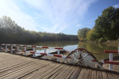 Güneşli bir günde, İtalya kırsalında ahşap platformlu ve raylı Pontoon Köprüsü