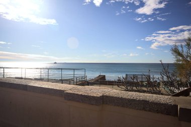 Güneşli bir günde deniz. Güneş ışığı suya vuruyor. Çerçevelenmiş bir balyoz tarafından.