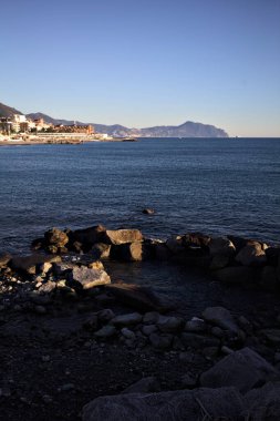 Deniz kenarındaki bina ve bulvar. Denizin üzerindeki küçük bir uçurumdan görülebiliyor. Kışın gün batımında sahneyi çerçeveliyorlar.