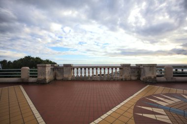 Bir gezinti güvertesinde balkonda tırabzanlar, üzerinde bulutlu bir gökyüzü, bir kış günü, denizi çerçeve