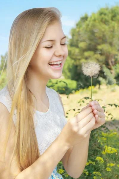 Karahindiba gülümseyen bir genç kızla