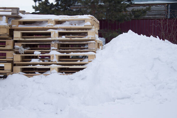 wooden pallets in the snow