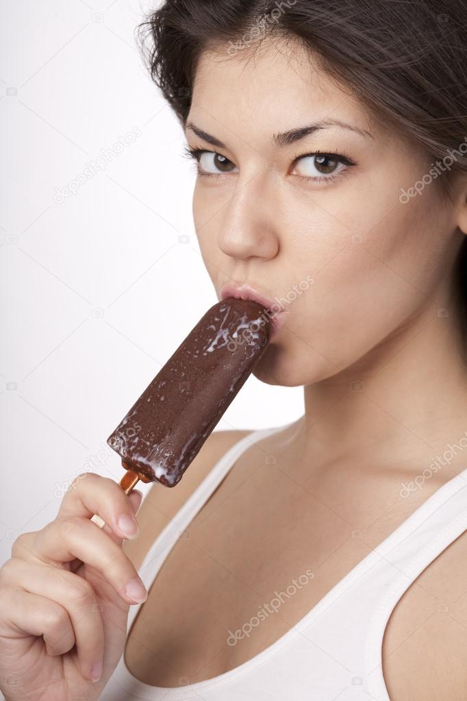 Sexy brunette woman licking chocolate Ice Cream