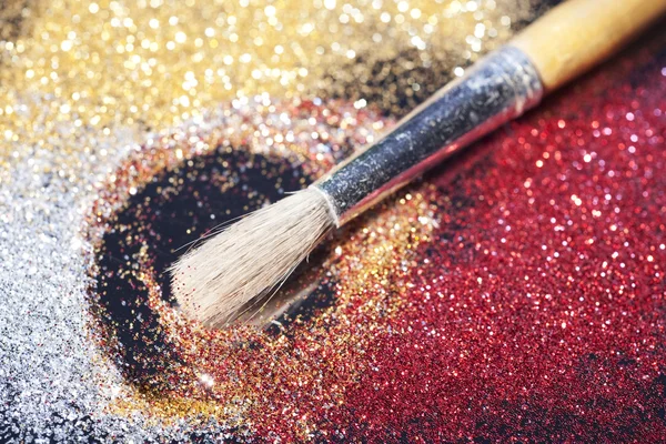 Close-up on makeup brush and colorful shining powders — Stock Photo, Image