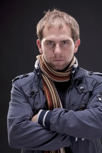 Portrait of young man with a jacket and scarf — Stock Photo, Image