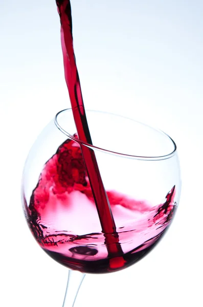 Red wine pouring into wine glass — Stock Photo, Image