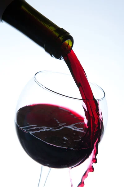 Red wine pouring into wine glass — Stock Photo, Image