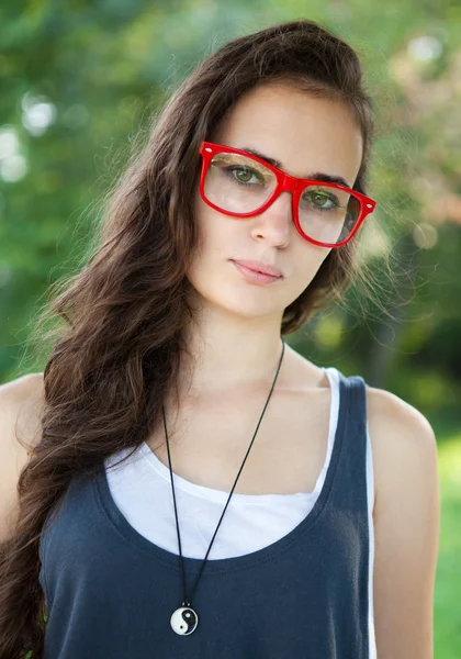 Bella ragazza con gli occhiali rossi nel parco — Foto Stock