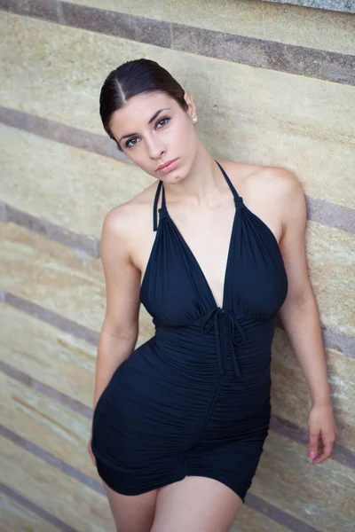 Mujer sexy joven con vestido negro posando al aire libre — Foto de Stock