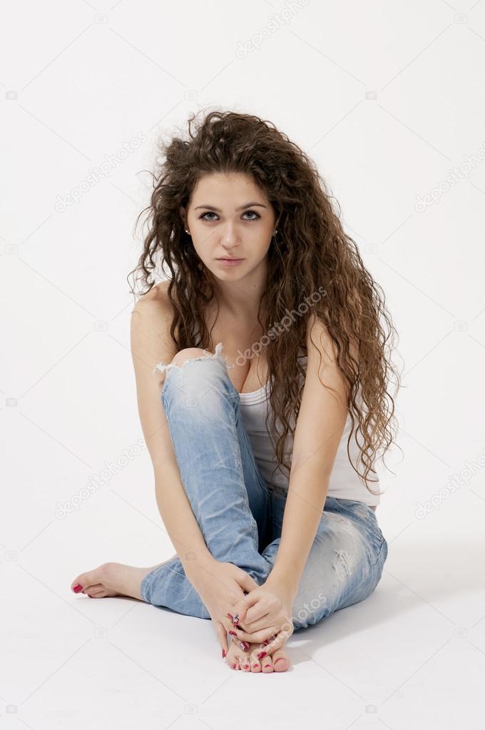 Foto de Sexy woman in swimsuit with the USA flag colors and jeans shorts.  Girl with perfect slim body. Studio shot. Long curly hair. do Stock