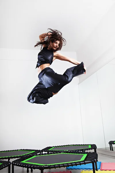Esmer kadın bir trambolin üzerinde atlama