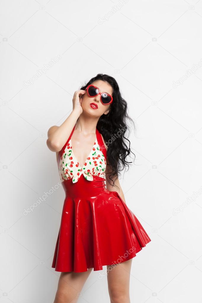 Sexy woman in red latex dress with sunglasses