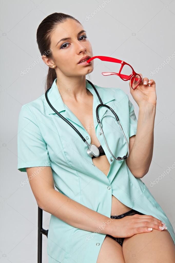 Sexy woman doctor with a stethoscope and red glasses sitting on chair Stock Photo by ©RVAS 83317374 photo