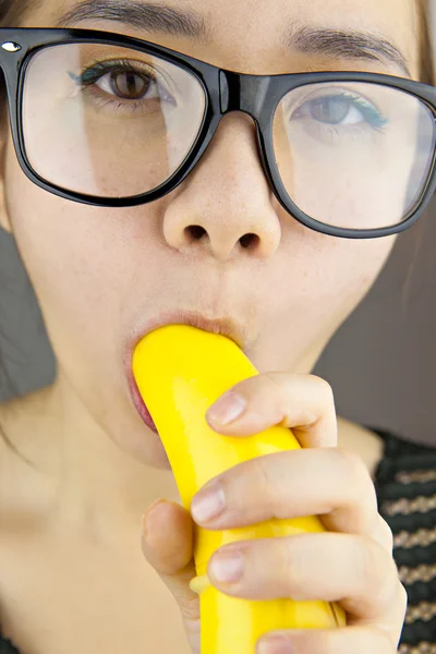 Beautiful woman with black sunglasses sexy eating banana Royalty Free Stock Images