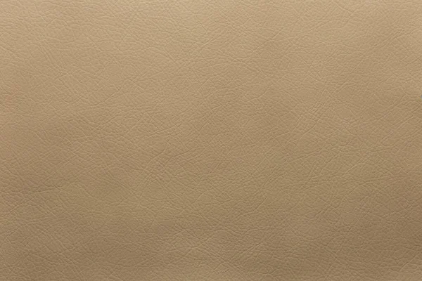 Dark beige artificial leather texture with a small pronounced embossing for background and design.