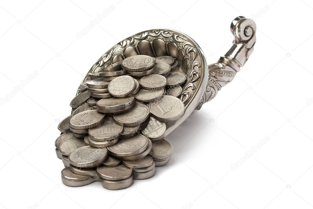 Silver coins pour out from the silver cornucopia. Isolated over white background. Half-turn view.