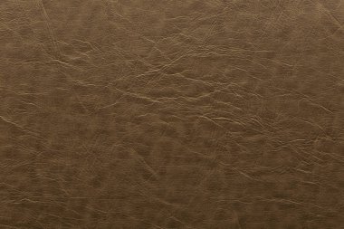 Kabartma şeklinde işaretlenmiş yapay deri kahverengi bir renk. Arkaplan ve tasarım için doku.