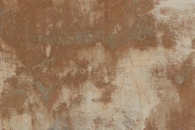 Kahverengi boya kalıntıları olan eski alçı duvarlar. Grunge dokusu.