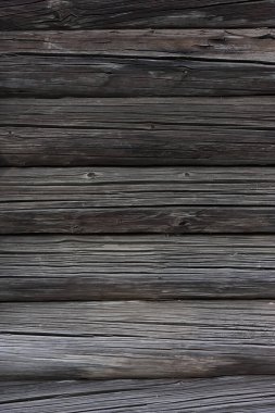 Fragment of a wall made of old dark logs.