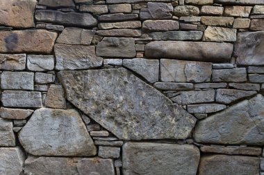 Doğal yontulmuş taştan duvar. Arkaplan ve tasarımlar için doku. Çokgen duvarcılık.