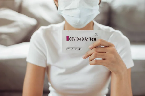 Woman self test for COVID-19 home test kit. asian woman using coronavirus covid-19 rapid antigen home testing kit, Coronavirus nasal swab test for infection.
