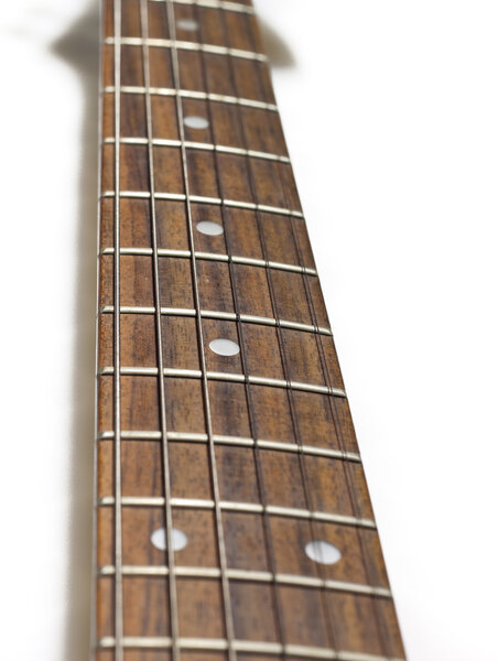 Fretboard of a huitar on a white background