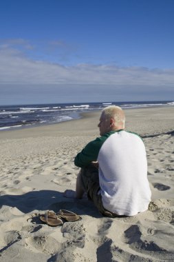 Genç adam okyanus izlerken