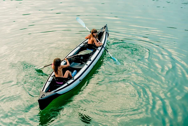 Twin sisters in a Canoe on the river in Ada Bojana, Montenegro