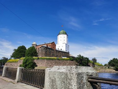 13. yüzyılda Vyborg şehrinde mavi gökyüzüne karşı inşa edilen Vyborg Kalesi ve St. Olaf Kulesi 'nin seddini görüyorsunuz..