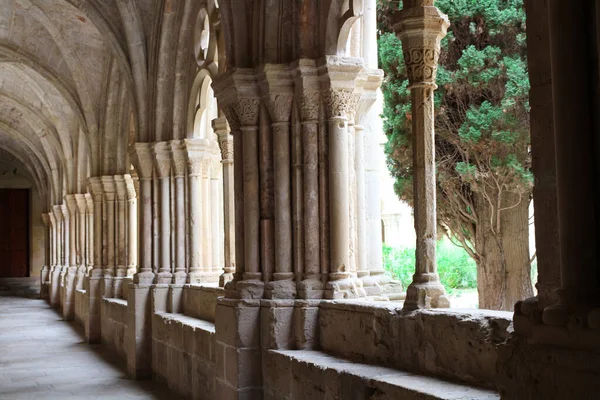 stock image Vaulted galleries and a fragment of the courtyard of the ancient monastery of Poblet (cat. Reial Monestir de Santa Maria de Poblet) Spain.