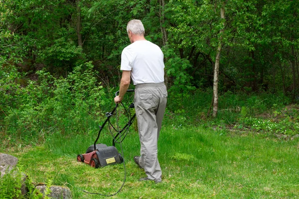 Man Mows Lawn Backyard Electric Lawn Mower Collecting Grass Stock Image