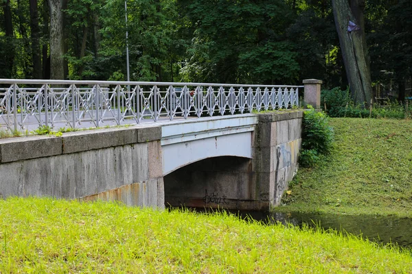 Granitgraue Brücke Über Den Fluss Von Einem Jungen Gemähten Rasen — Stockfoto